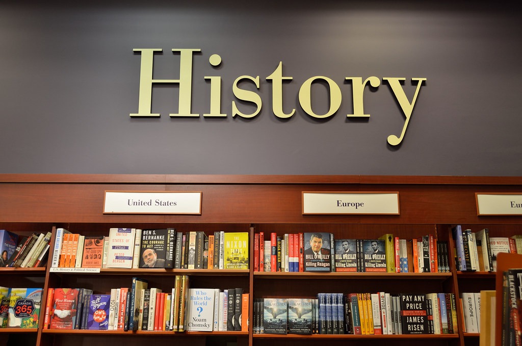 picture of the word History above shelves of books